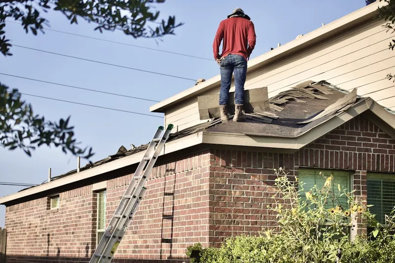 Professional roofer working on a residential roof in Ingomar